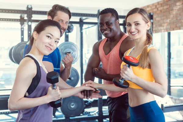 Four friends in the gym having fun — Stock Photo, Image