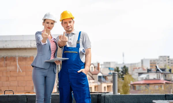 Architect and Construction worker on site giving the finger — Stock Photo, Image