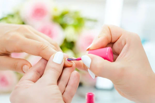 Experienced nail technician applying nail color — Stock Photo, Image