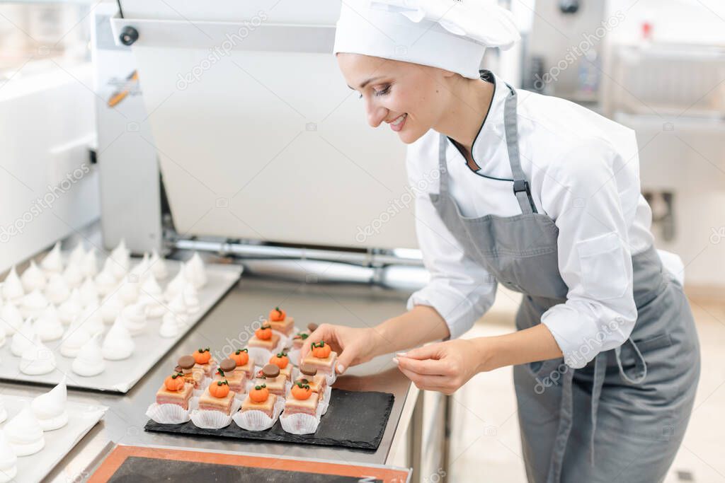 Paitssier putting petite fours on a sheet