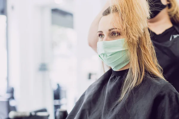 Mujer visitando a la peluquera con máscara facial —  Fotos de Stock