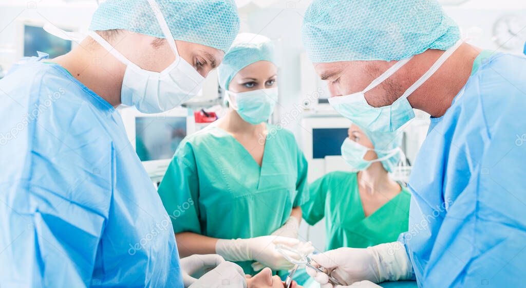 Surgeons or doctors in operating room of hospital