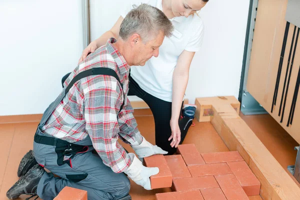 Trabalhador em terapia ocupacional reaprender a colocar tijolos — Fotografia de Stock