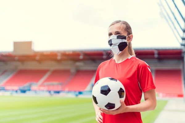 Női focista maszkot visel az üres stadionban — Stock Fotó