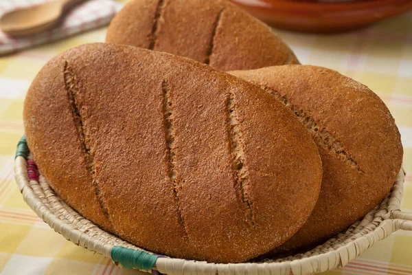Basket with fresh baked moroccan brown bread