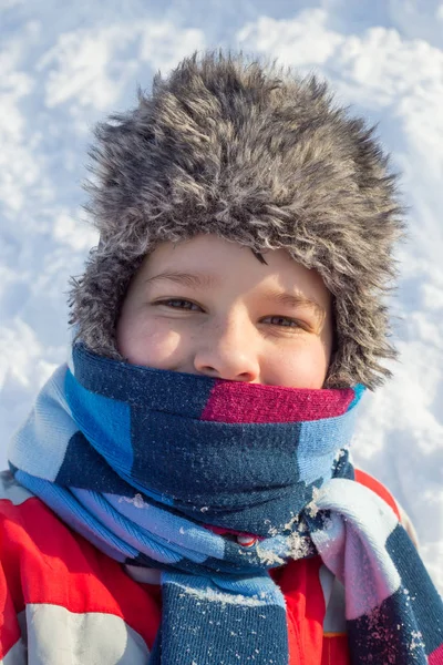 Adorable smiling boy at the snow background — Stock Photo, Image