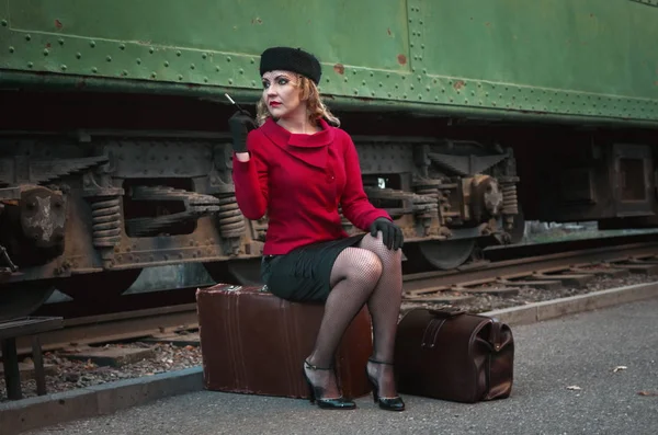 Retro woman on the train station