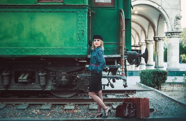 Retro woman on the train station