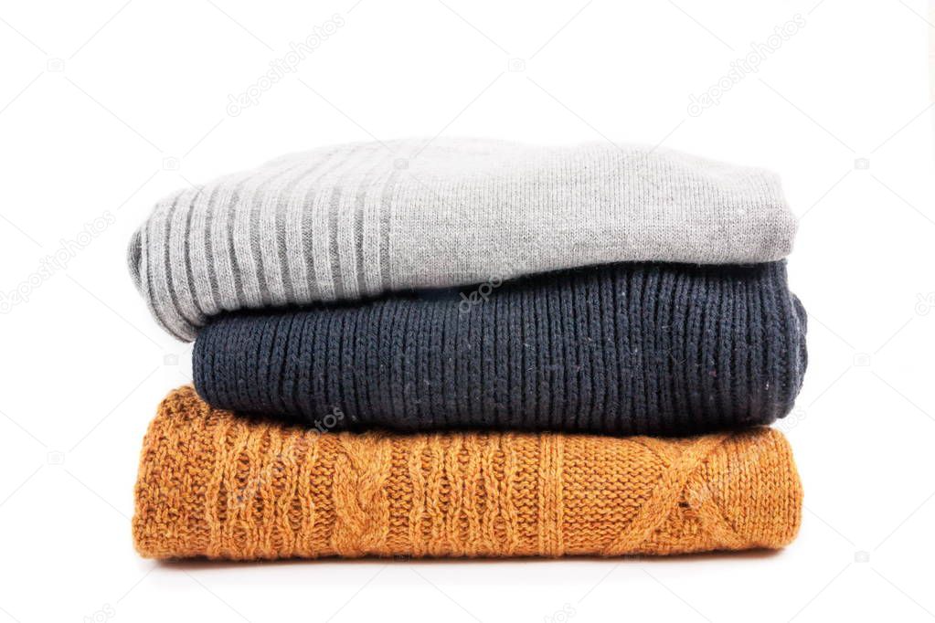 Sweaters in the stack on the white