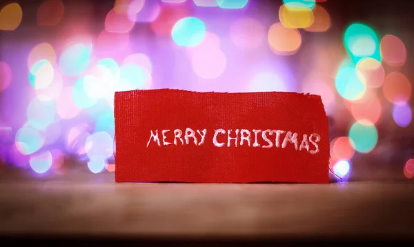 Inscription merry Christmas on a festive blurred background . — Stock Photo, Image
