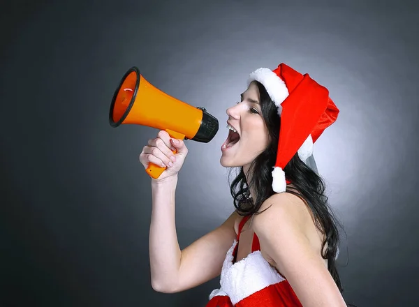 Young woman dressed as Santa Claus shouting into a megaphone — Stock Photo, Image