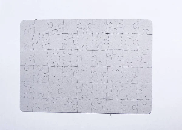 Pajzs szoros up.blank össze a puzzle darabkái, fehér háttér — Stock Fotó