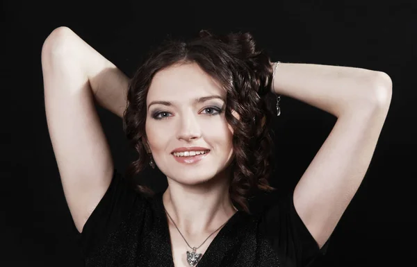 Beautiful woman with evening make-up sitting in a chair. — Stock Photo, Image