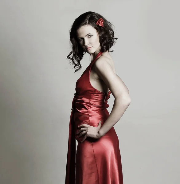 Portrait of a modern young woman in a red evening dress — Stock Photo, Image