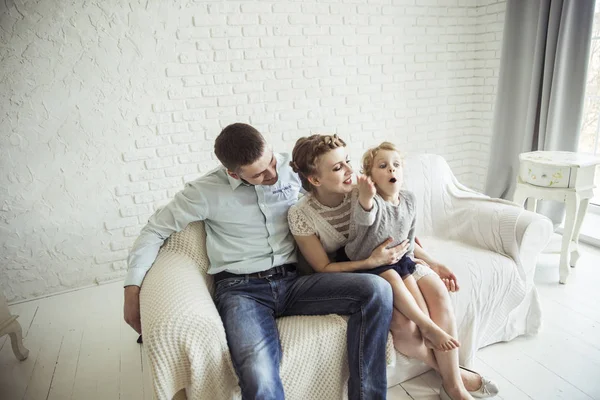 Retrato de la familia feliz sentado en el sofá en la sala de estar —  Fotos de Stock