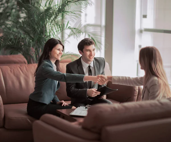 Apretón de manos del gerente y el cliente después de la discusión del contrato en el vestíbulo de la oficina moderna — Foto de Stock