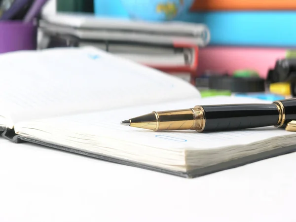 Close up. Diario e penna a sfera sullo sfondo delle forniture scolastiche — Foto Stock