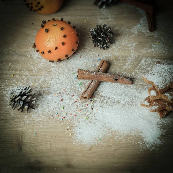 Christmas table. background image of cinnamon sticks,oranges an