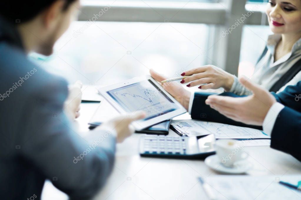 Image of human hand pointing at touchscreen in the working environment at meeting