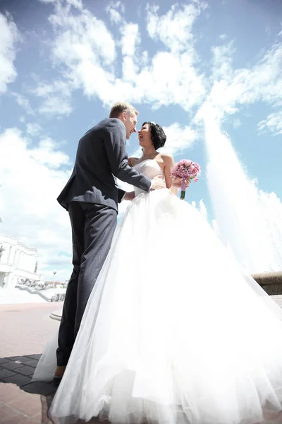 Heureux marié et mariée sur le fond de la ville — Photo