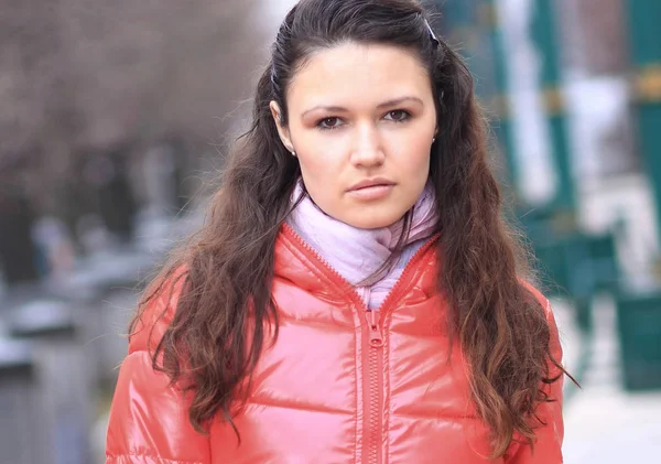 close up.serious young woman on the background of a winter city