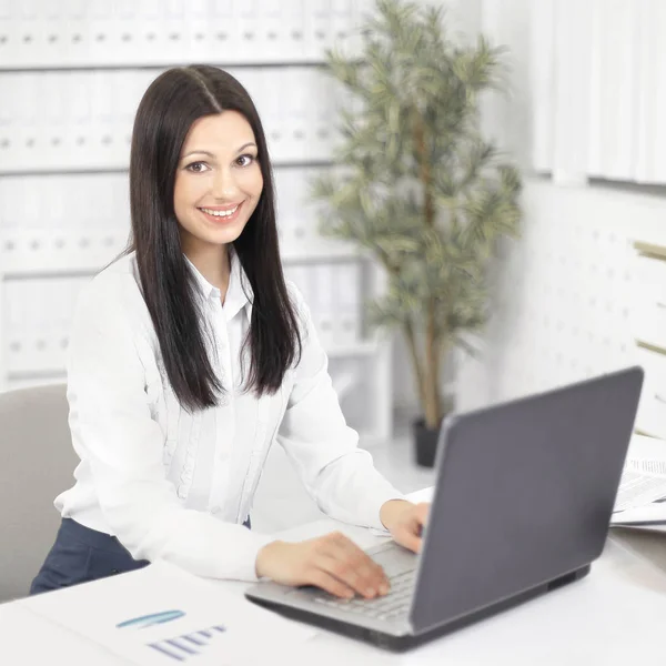 Asistente femenina trabajando en el ordenador portátil en la oficina — Foto de Stock
