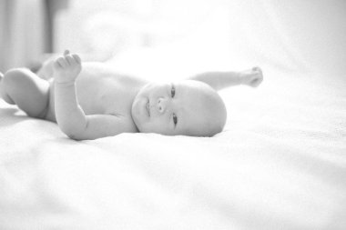siyah-beyaz fotoğraf retro tarzı - yatarken şirin gülümseyen bebek