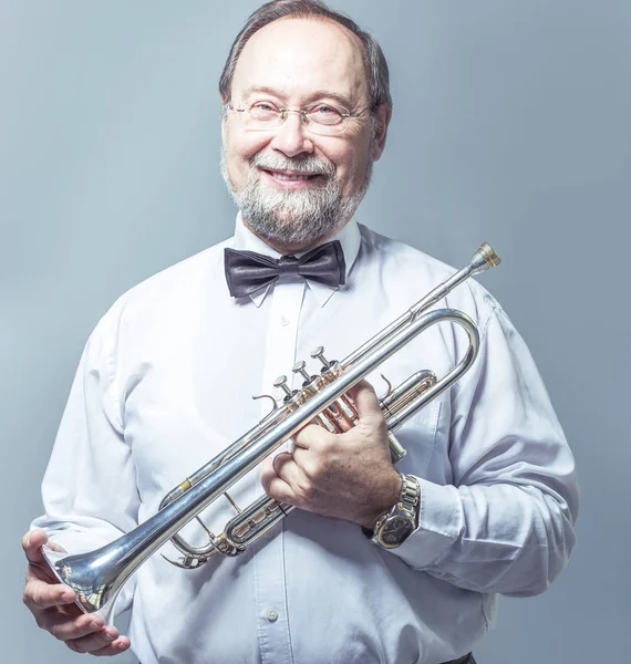 Retrato de um músico com um tubo sobre um fundo claro — Fotografia de Stock