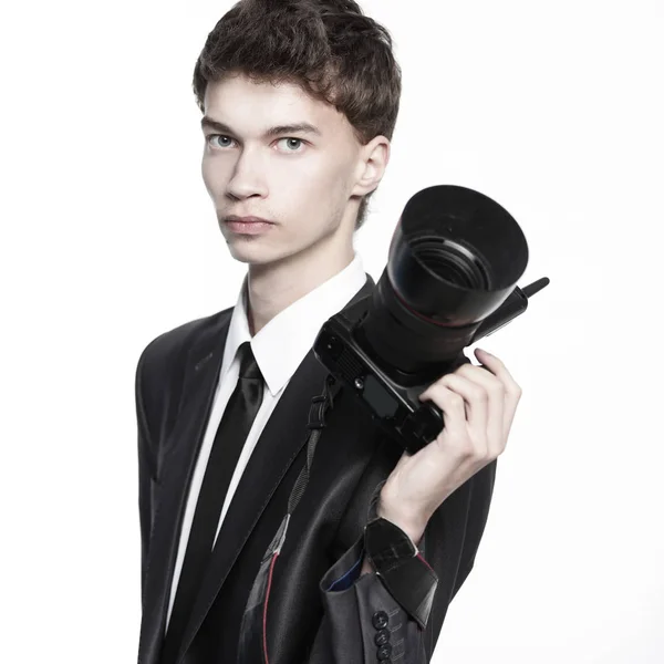 Portrait of young handsome photographer holding the camera — Stock Photo, Image