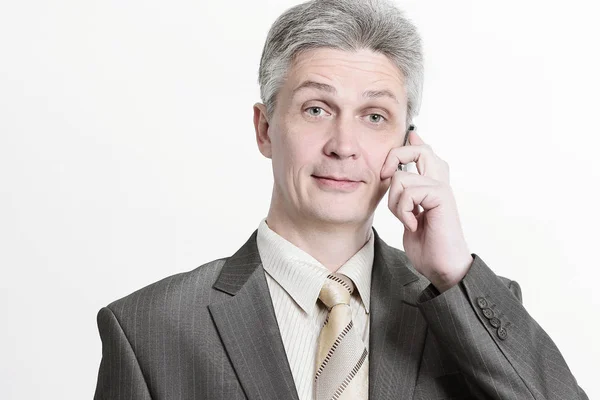 Senior businessman talking on mobile phone.isolated on a white — Stock Photo, Image