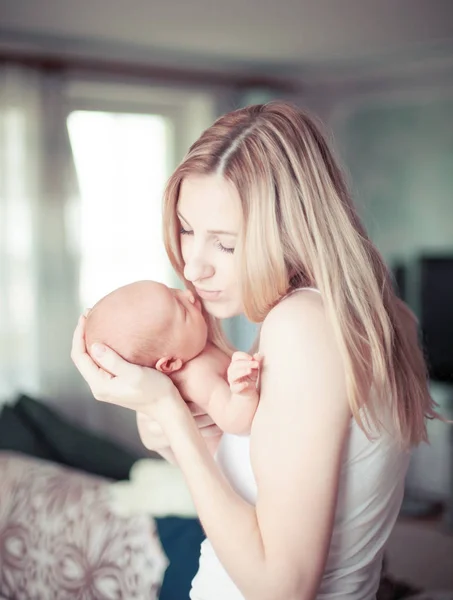 Happy mother holding a newborn child — Stock Photo, Image