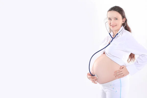 Zwangere vrouw haar baby luisteren met een stethoscoop , — Stockfoto