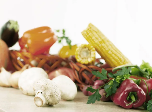 Mushrooms on a background of fresh vegetables. — Stock Photo, Image