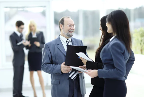 Close up .group of business people standing in lobby of office . — стоковое фото