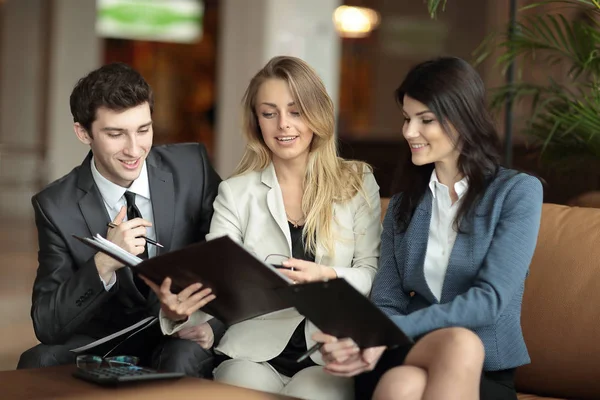 Close up.colleagues discussing the financial document in the lobby of the Bank — Stock Photo, Image