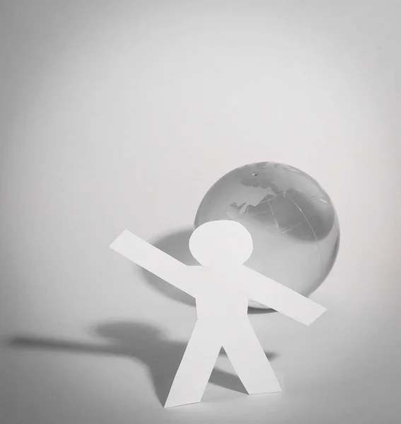 Стильный бумажный человек, стоящий у глобуса — стоковое фото