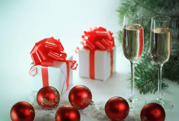 Two glasses with champagne and Christmas gifts at the Christmas — Stock Photo, Image