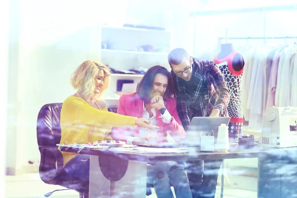 view from behind glass.creative team discusses new ideas in the Studio