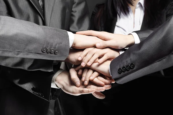 Close up.a group of business people folded their hands together — Stock Photo, Image