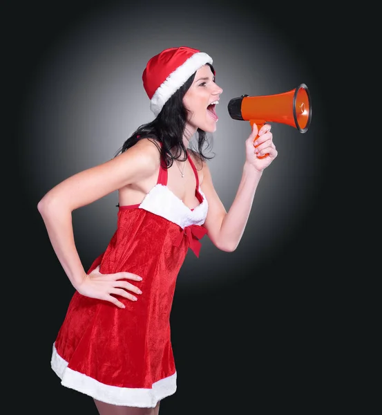 Young woman dressed as Santa Claus shouting into a megaphone — Stock Photo, Image