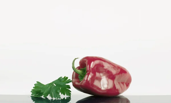 Pimentão maduro e um ramo de salsa. Isolado em um branco — Fotografia de Stock