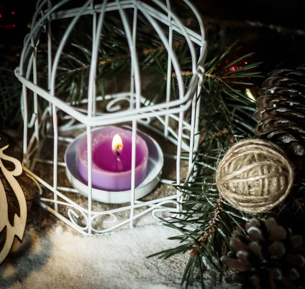 Christmas candle and festive accessories on a black background. — Stock Photo, Image