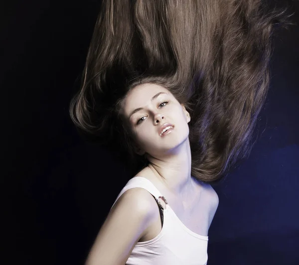 Αυτοπεποίθηση νεαρή γυναίκα με μακριά μαλλιά .isolated σε μια μαύρη backg — Φωτογραφία Αρχείου