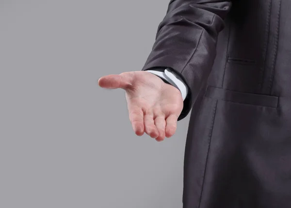close up. the businessman reaches out to the partner .isolated on grey background