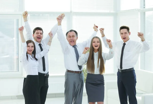 Grupo de jóvenes felices en ropa formal celebrando, haciendo gestos, manteniendo los brazos levantados — Foto de Stock