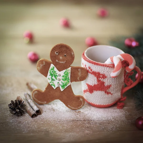 Christmas Cup ornament and candy on a wooden table — Stock Photo, Image