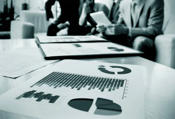 Charts and graphs with documents in the background of the team — Stock Photo, Image