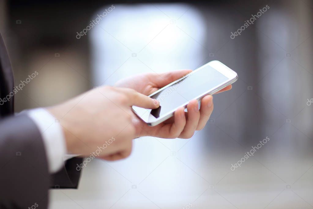 close up.the businessman clicks on the smartphone screen