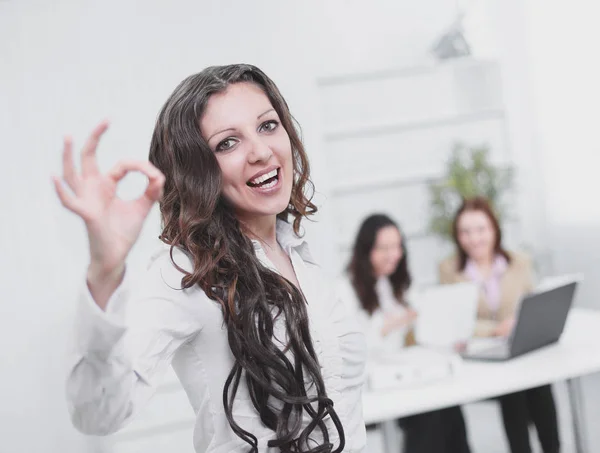 Closeup.successful business woman showing OK sign in office — Stock Photo, Image