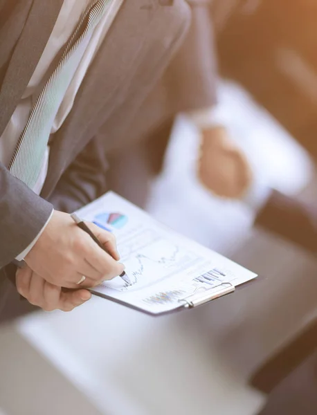 Close up. businessman with financial graph on background of bus — Stock Photo, Image